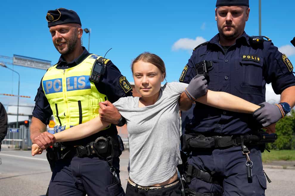 <p>Greta Thunberg is detained by police (AP Photo/Pavel Golovkin)</p>