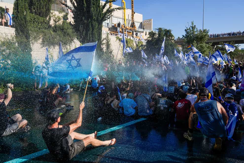 Israeli police in Jerusalem use a water cannon to disperse demonstrators blocking a road during a protest against plans by Prime Minister Benjamin Netanyahu’s government to overhaul the judicial system (Ohad Zwigenberg/AP)
