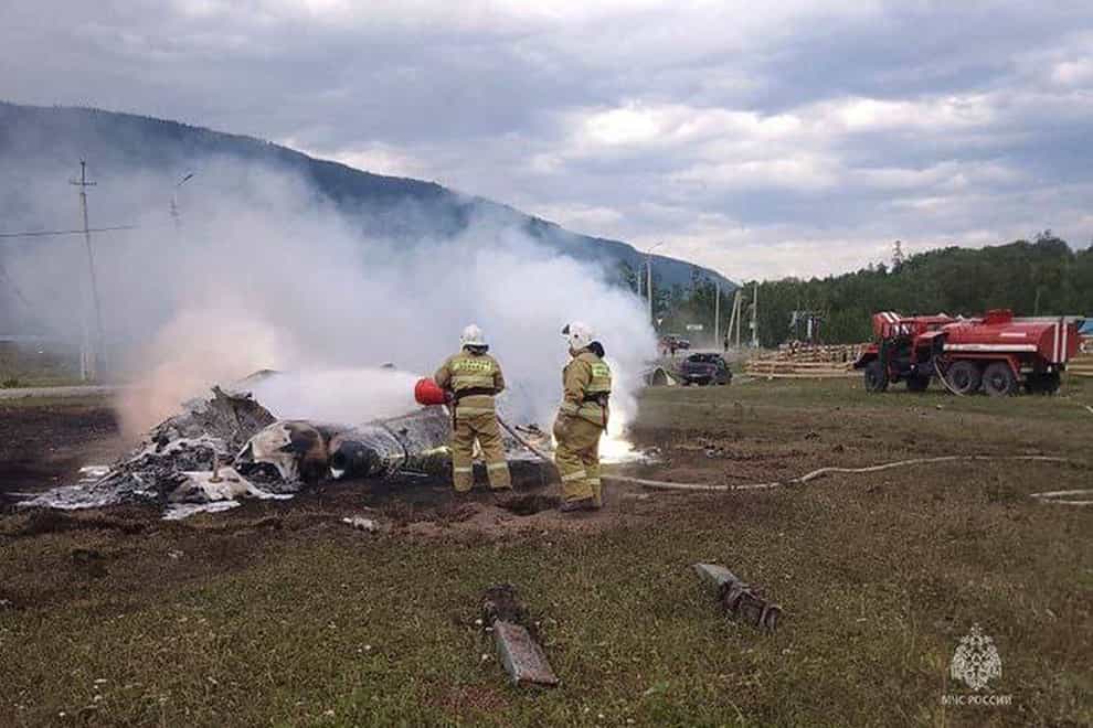 Firefighters extinguish flames after an Mi-8 helicopter crash near Tyungur village, Altai Republic, southern Siberia, Russia (Ministry of Emergency Situations/AP)
