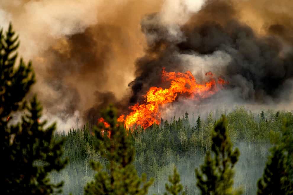 A firefighter has been killed while battling a massive wildfire in north-eastern British Columbia – the second such fatality in the Canadian province this month and the fourth in Canada during this year’s record fire season (Noah Berger/AP)