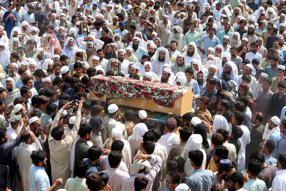 Relatives and mourners carry the casket of a victim who was killed in Sunday’s attack in the Bajur district of Khyber Pakhtunkhwa (AP)