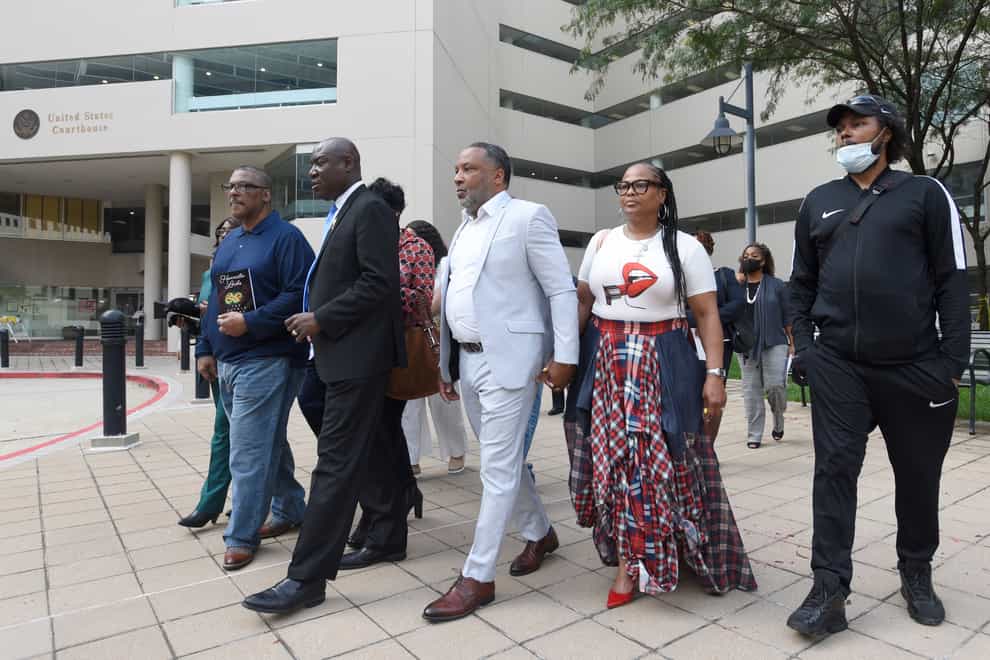 Lawyer Ben Crump, second from left, walks with Ron Lacks, left, Alfred Lacks Carter, third from left, both grandsons of Henrietta Lacks, and other members of her family (AP Photo/Steve Ruark, file)