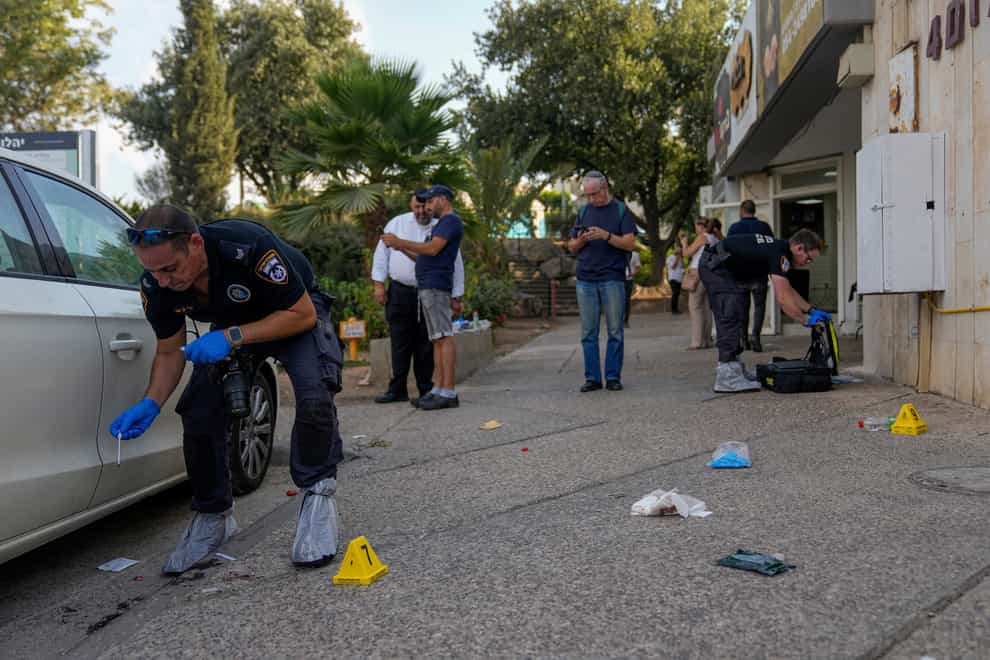 Israeli police inspect the site of a shooting in the West Bank Israeli settlement of Maale Adumim (Ohad Zwigenberg/AP/PA)