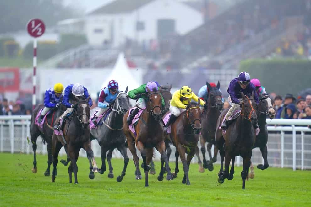 Magical Sunset (right, purple) wins the Oak Tree at Goodwood (Andrew Matthews/PA)