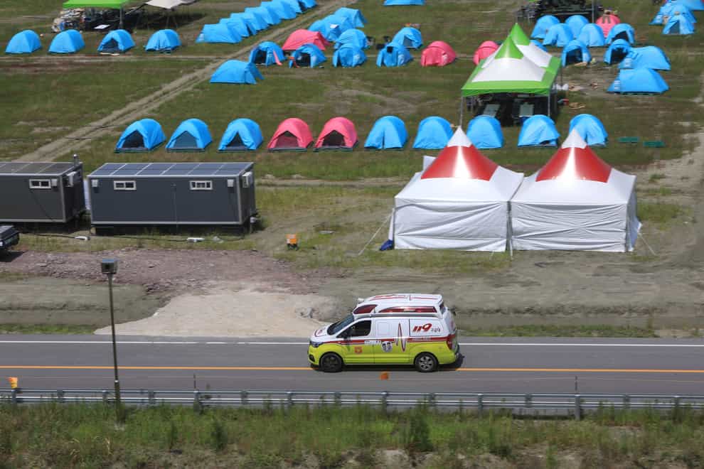 An ambulance passes a scout camping site during the World Scout Jamboree in Buan, South Korea (Jeonbuk Fire Station/Yonhap via AP)