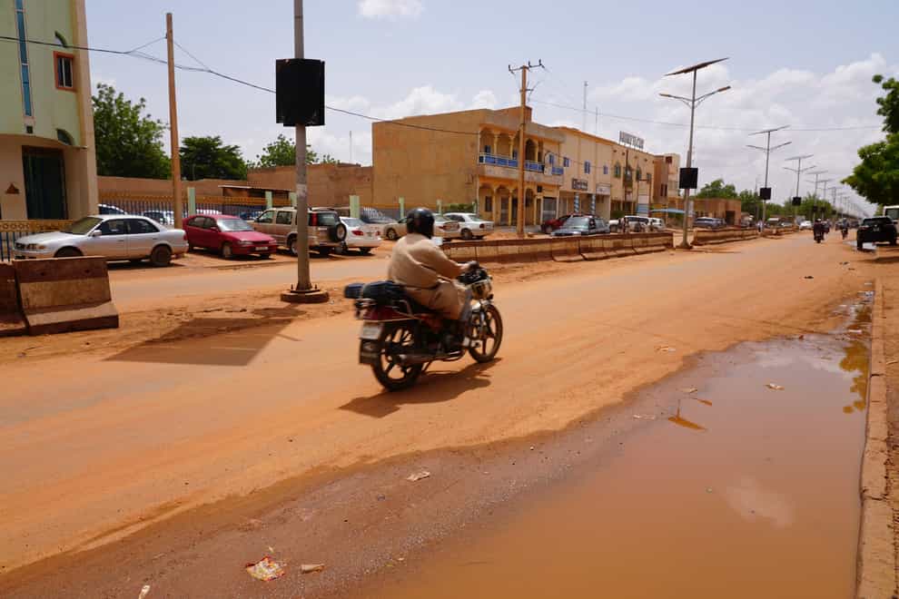 A lone motorcyclist rides in Niamey, Niger (Sam Mednick/AP)