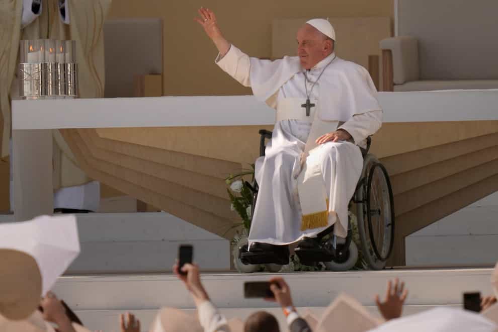 Pope Francis waves to the crowd during a mass celebrating the 37th World Youth Day (Francisco Seco/AP)