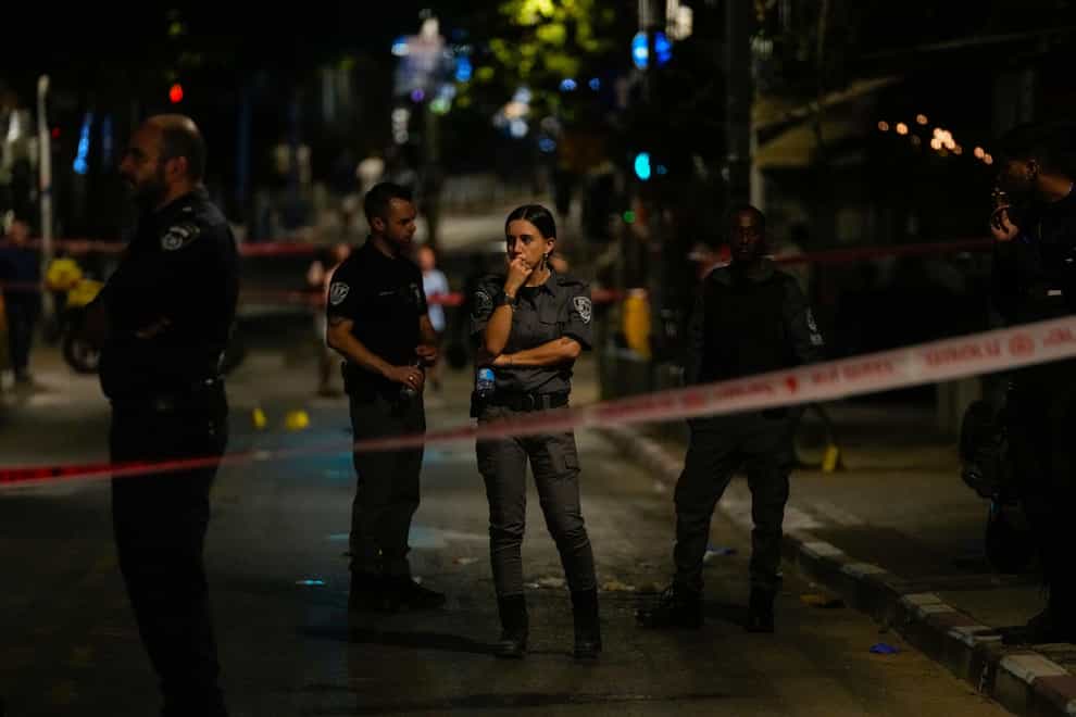 Israeli police inspect the site of a shooting attack in Tel Aviv (Maya Alleruzzo/AP)