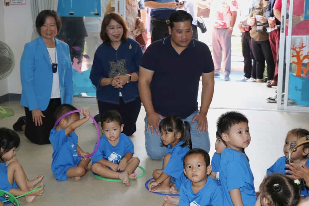 Vacharaesorn Vivacharawongse, centre right, visited a daycare centre in Bangkok (Foundation For Slum Child Care via AP)