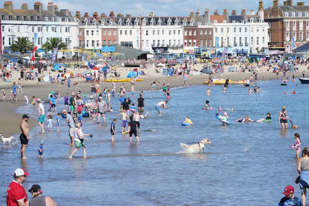 Beachgoers on Weymouth beach in Dorset on Wednesday (Ben Birchall/PA)