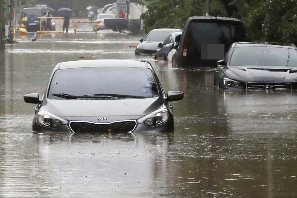 Vehicles are submerged in floodwaters caused by the tropical storm in Changwon, South Korea (Chung Jong-ho/Yonhap via AP)