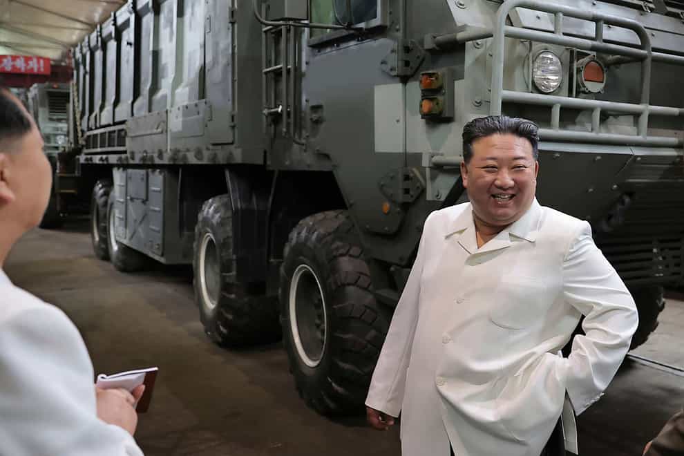 North Korean leader Kim Jong Un in front of a military vehicle during a visit to a factory (Korean Central News Agency/Korea News Service via AP)