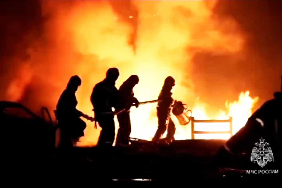 Firefighters try to extinguish a blaze at a petrol station (Ministry of Emergency Situations press service via AP)