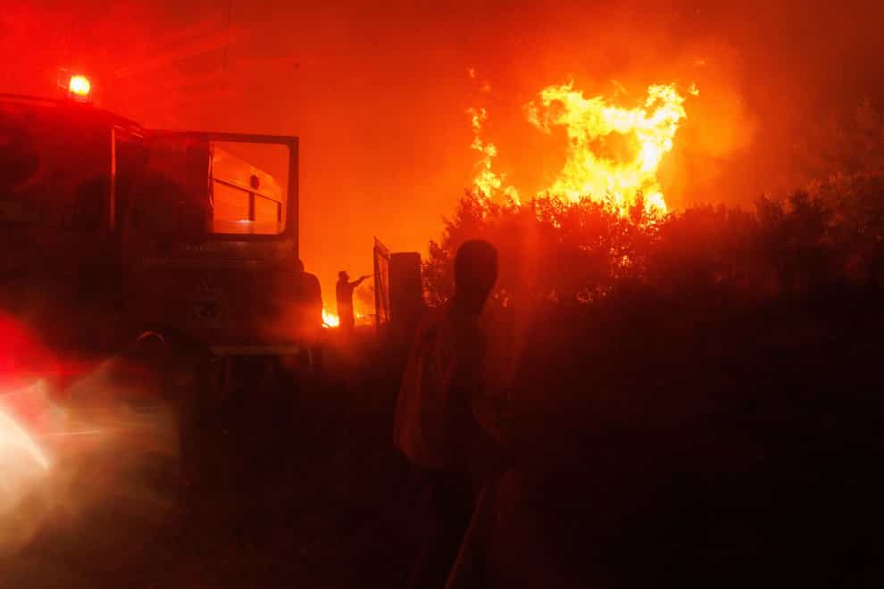 Greek firefighters have found the bodies of 18 people in an area of north-eastern Greece ravaged by a major wildfire that has been burning for days (Achilleas Chiras/AP)