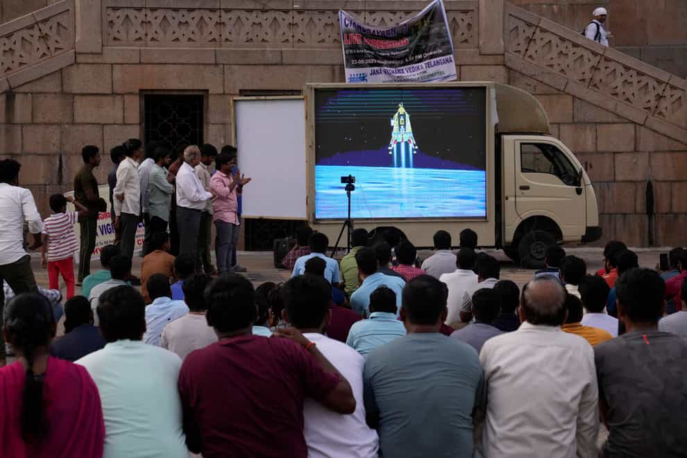 People watch the landing of Chandrayaan-3 at Omani University in Hyderabad (Mahesh Kumar/AP)
