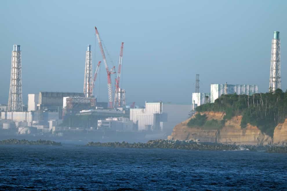 The Fukushima Daiichi nuclear power plant, damaged by a massive March 11, 2011, earthquake and tsunami, is seen from the nearby Ukedo fishing port in Namie town, northeastern Japan, Thursday, Aug. 24, 2023. The Fukushima Daiichi nuclear power plant will start releasing treated and diluted radioactive wastewater into the Pacific Ocean as early as Thursday. (AP Photo/Eugene Hoshiko)