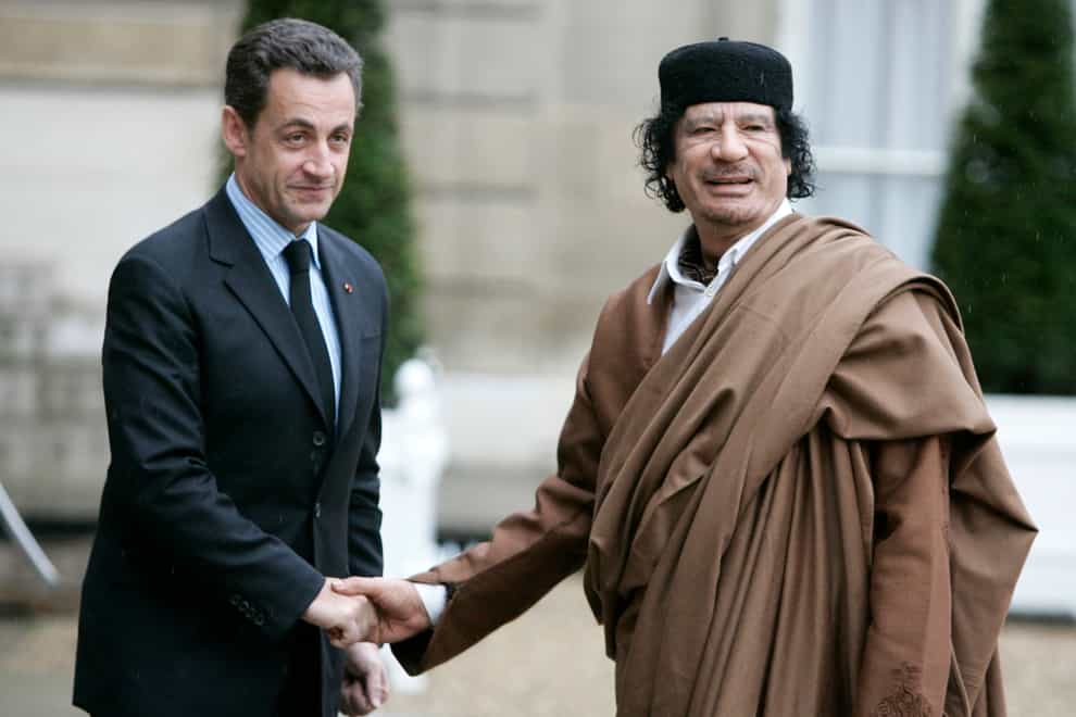 Nicolas Sarkozy greets Libyan leader Col Muammar Gaddafi upon his arrival at the Elysee Palace, in Paris in December 2007 (AP)