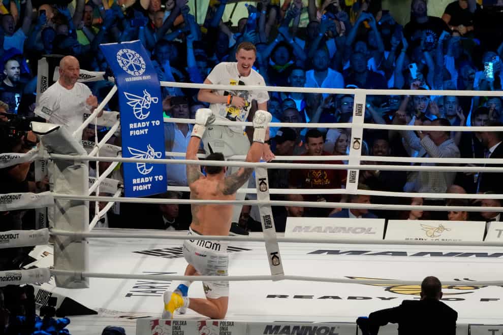 Ukraine’s Oleksandr Usyk celebrates after beating Britain’s Daniel Dubois (Czarek Sokolowski/AP)
