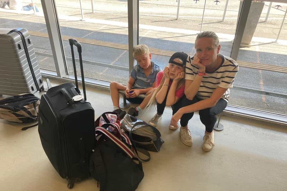 Joanne Dollard with children Emily, 10, and Arthur, eight, stuck at Bergerac Dordogne Perigord airport in France (Rory Dollard/PA)