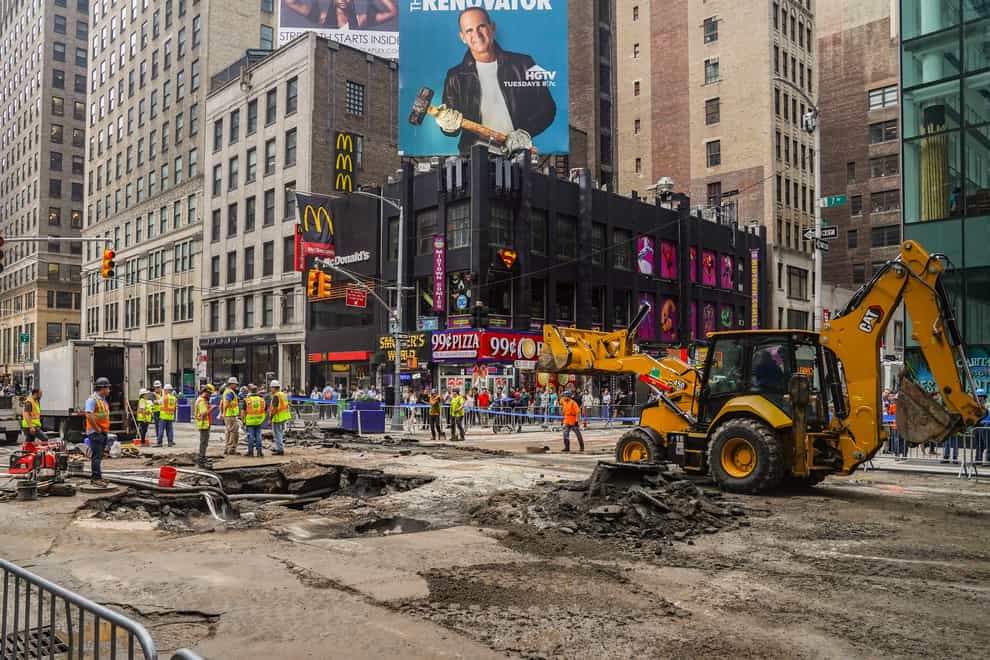 Work crews begin repair after a 127-year-old water main under New York’s Times Square gave way under 40th Street and Seventh Avenue (Bebeto Matthews/AP/PA)
