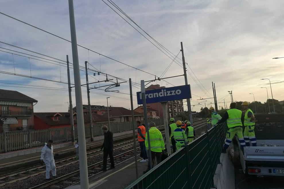 Firefighters inspect the site where five railway workers were killed at a station in Brandizzo, near Turin (LaPresse via AP)