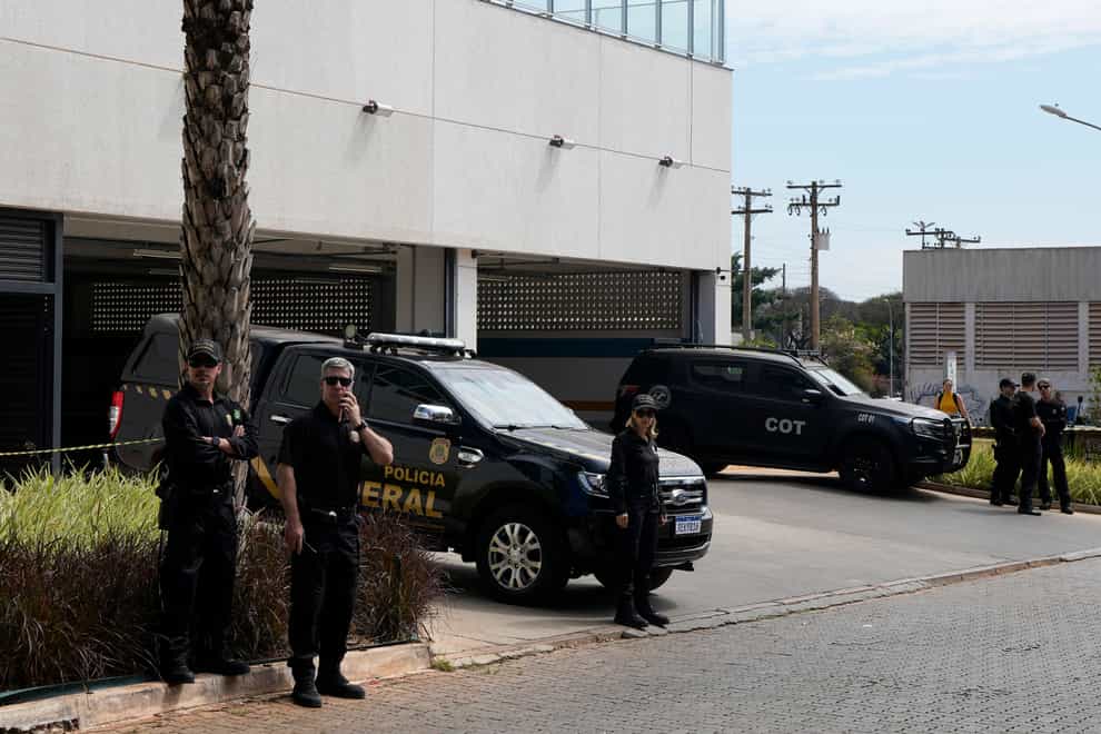 Federal Police agents at Federal Police headquarters before the arrival of Brazil’s former president Jair Bolsonaro in Brasilia (Eraldo Peres/AP)