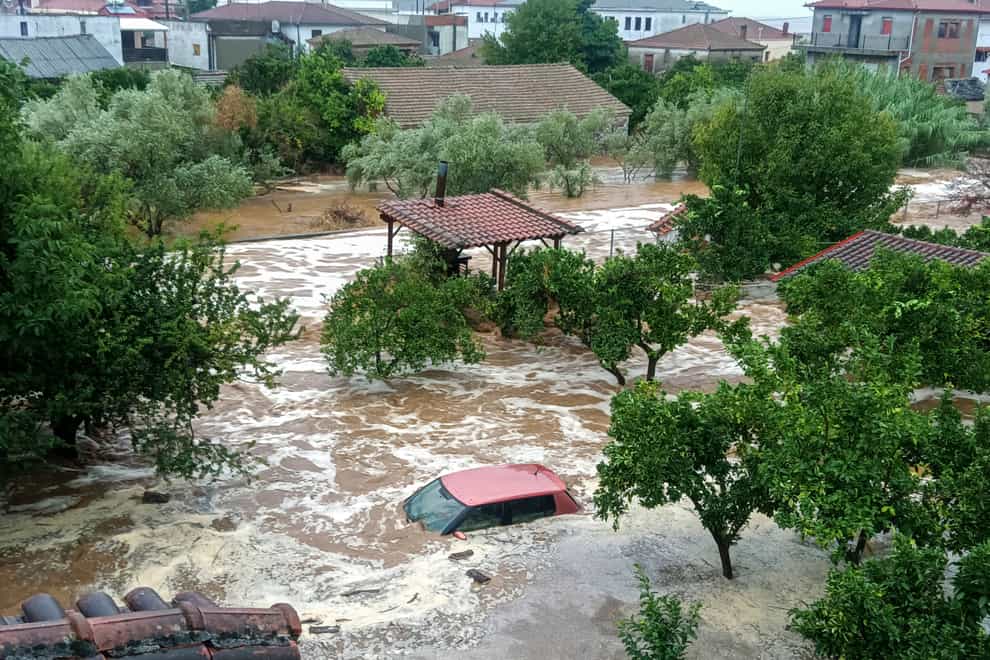 Floodwater covered a car in Milina village (Thanasis Kalliaras/Eurokinissi via AP)