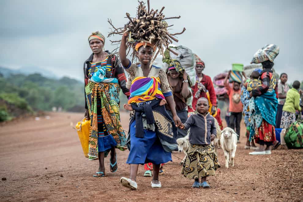 People flee fighting between M23 rebels and Congolese forces near Kibumba, some 12 miles north of Goma in the Democratic Republic of Congo (Moses Sawasawa/AP)