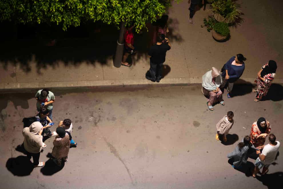 People take shelter and check for news on their mobile phones after an earthquake in Rabat, Morocco, Friday, Sept. 8, 2023. A powerful earthquake struck Morocco late Friday, damaging buildings in major cities and sending panicked people pouring into streets and alleyways from Rabat to Marrakech (Mosa’ab Elshamy/AP)
