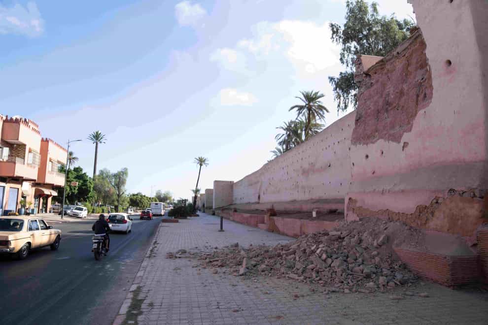 People drive past a damaged wall of the historic Medina of Marrakesh after the earthquake (Mosa’ab Elshamy/AP/PA)