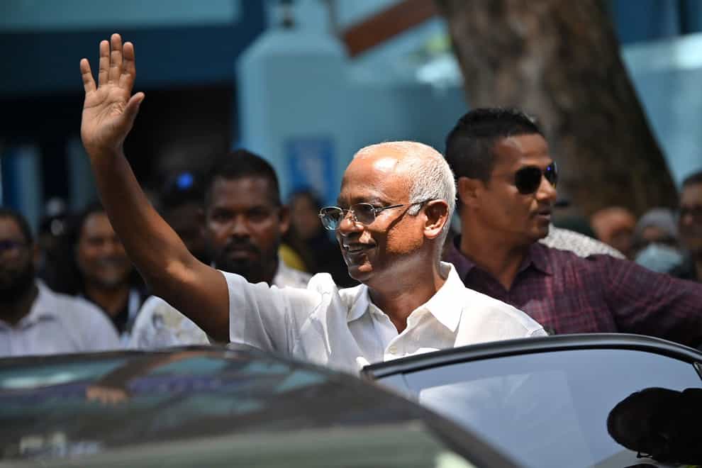 President Mohamed Solih waves after casting his vote at a polling station in Male, Maldives (Mohamed Sharuhaan/AP/PA)