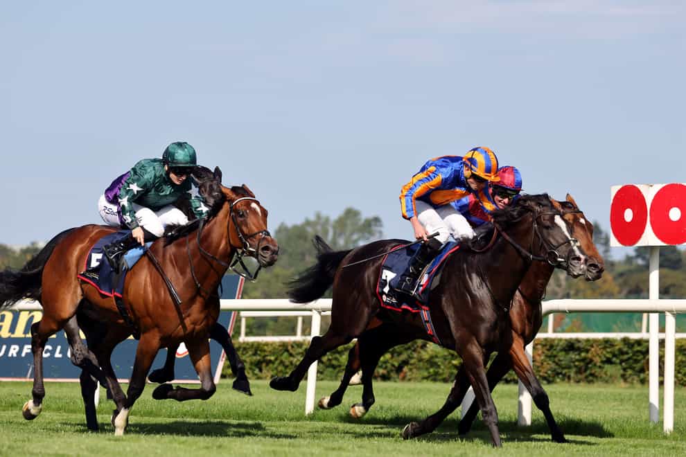 Auguste Rodin ridden by jockey Ryan Moore (orange/blue) on their way to winning the Royal Bahrain Irish Champion Stakes at Leopardstown Racecourse, Dublin. Picture date: Saturday September 9, 2023.