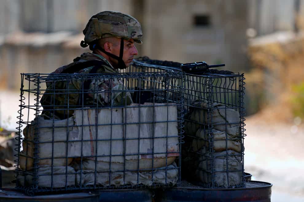 Lebanese army soldiers are guarding the entrance of Palestinian refugee camp of Ein el-Hilweh (AP)