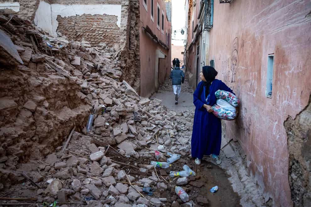 A woman looks at the rubble of a building in the earthquake (FADEL SENNA/AFP/Getty Images/Intrepid)