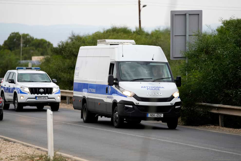 A police van carrying the five Israelis who are accused of raping a British woman arrives at the Famagusta District Courthouse (Petros Karadjias/AP)