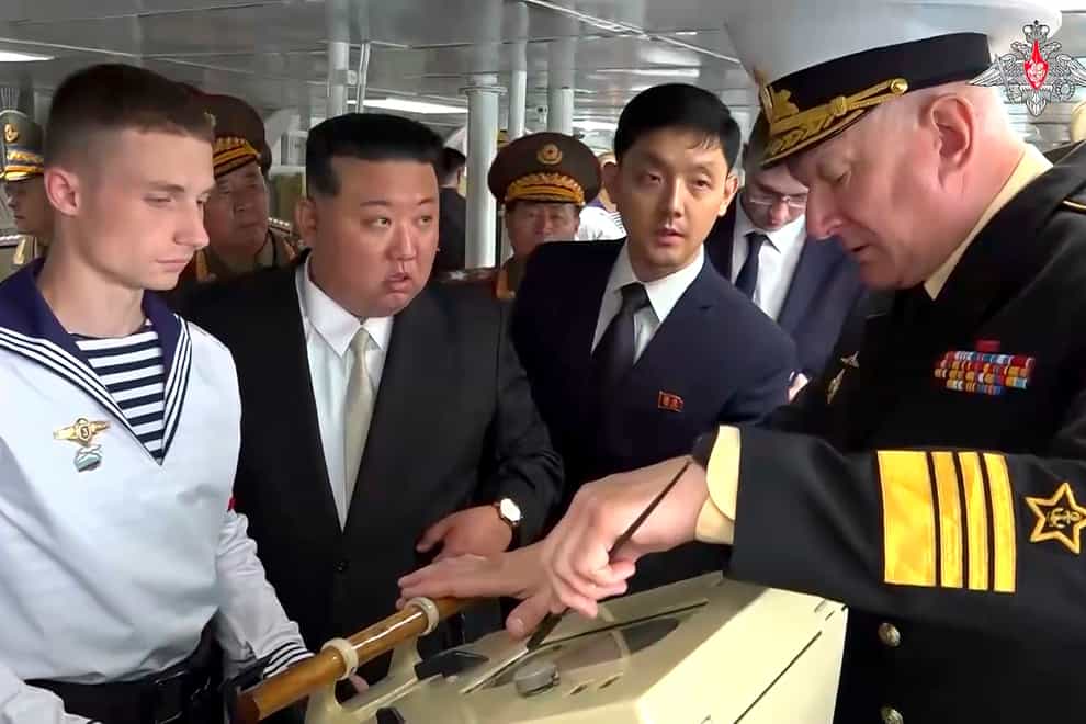 Kim Jong Un listens to Admiral Nikolai Yevmenov, Commander-in-Chief of the Russian Navy, right, while visiting the Admiral Shaposhnikov frigate (Russian Defence Ministry Press Service via AP)
