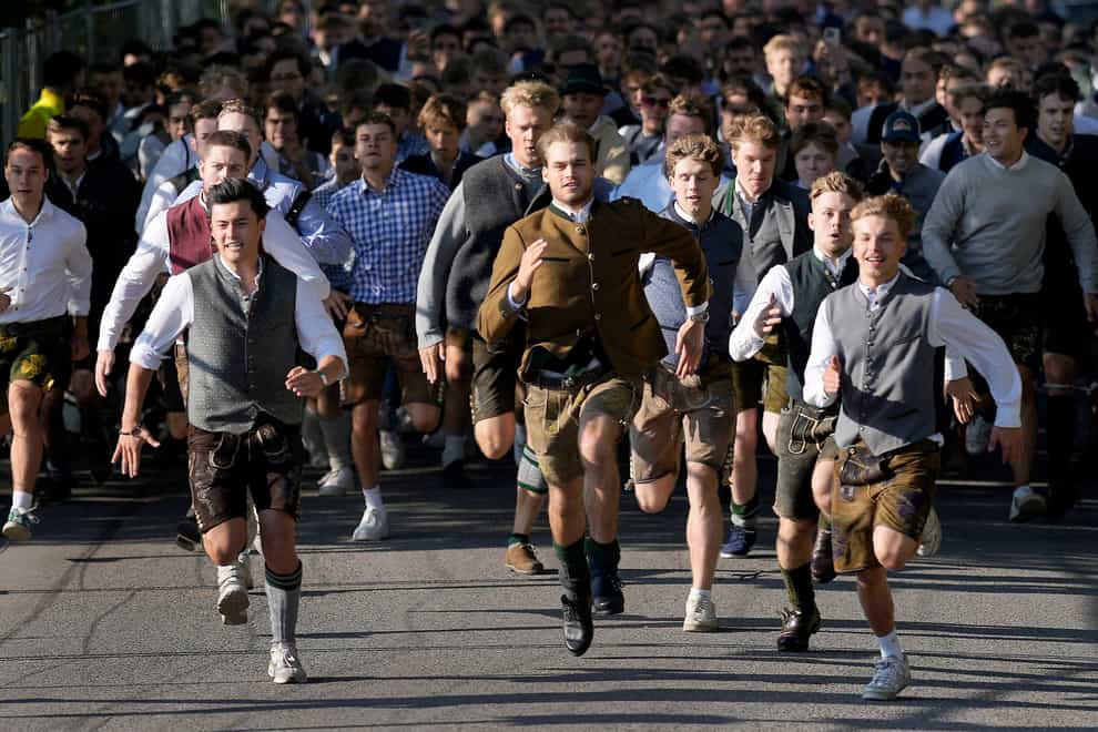 People run to enter the 188th Oktoberfest beer festival in Munich, Germany (Matthias Schrader/AP)