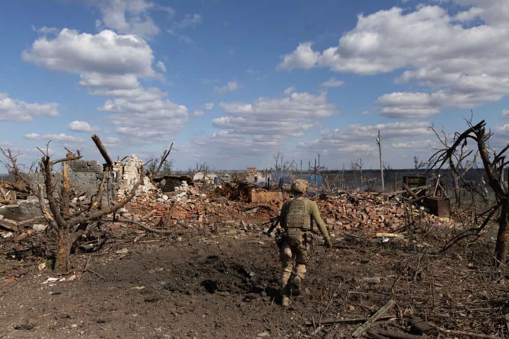 An assault unit commander runs to his position at the frontline in Andriivka, Donetsk region (Alex Babenko/AP)