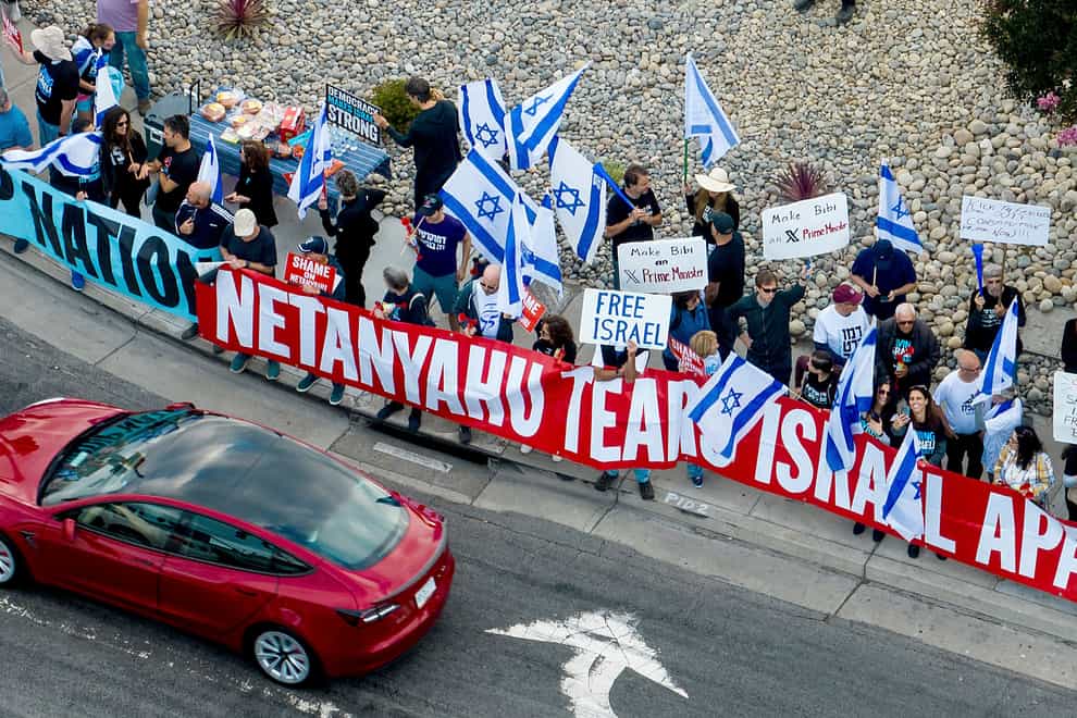 Protesters rally outside Tesla’s factory in Fremont, California, as Israeli Prime Minister Benjamin Netanyahu visited businessman Elon Musk (Noah Berger/AP/PA)