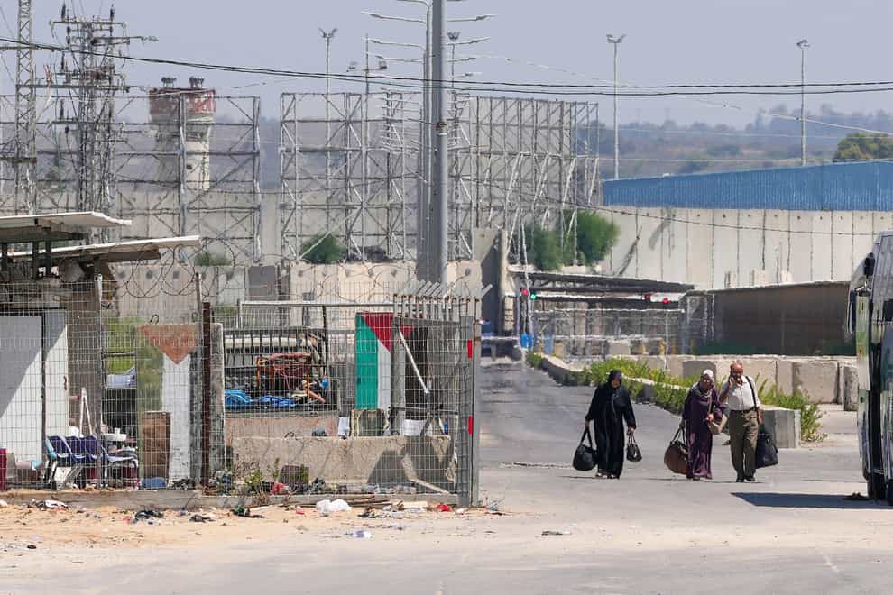 Palestinian patients carry their belongings on their way back to the Gaza Strip after receiving medical treatment in Israel, near the Erez crossing between Gaza and Israel Israel shut down the main personnel crossing between Israel and Gaza to thousands of Palestinian laborers on Tuesday, following a resurgence of violent protests at the Israeli border fence (Adel Hana/AP/PA)