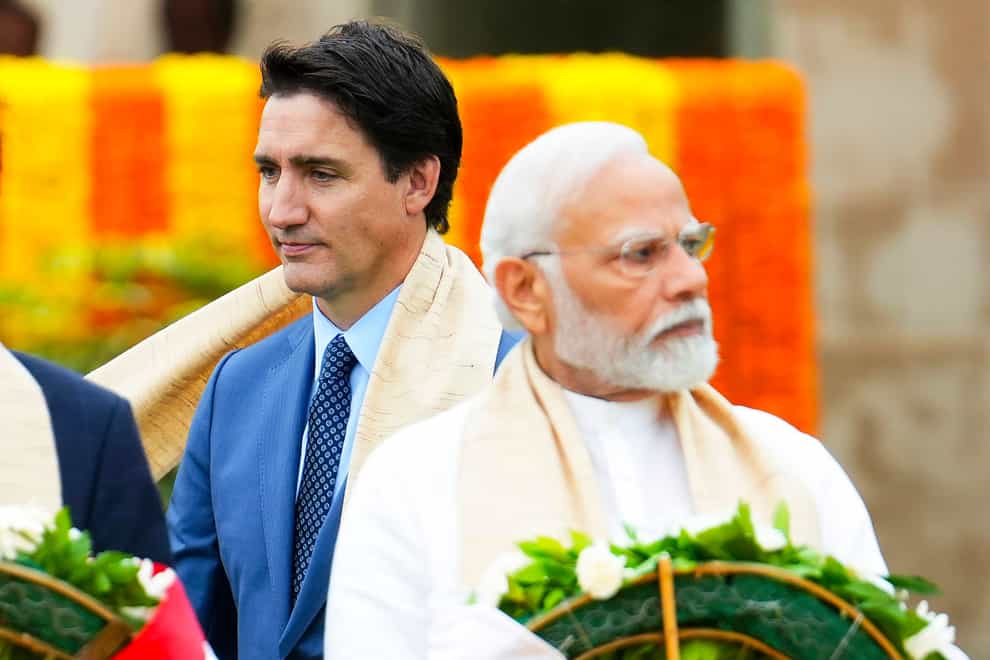 Canada’s Prime Minister Justin Trudeau, left, walks past Indian Prime Minister Narendra Modi (Sean Kilpatrick/The Canadian Press via AP)
