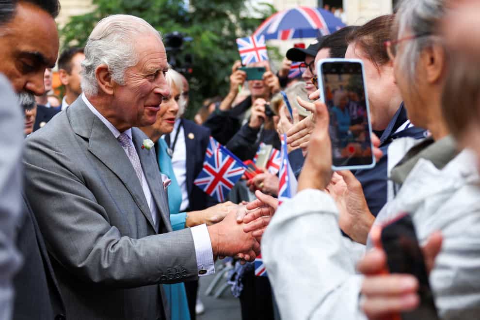 King Charles and Queen Camilla shook hands with members of the public who had turned out to see them arrive in Bordeaux (Hannah McKay/PA)