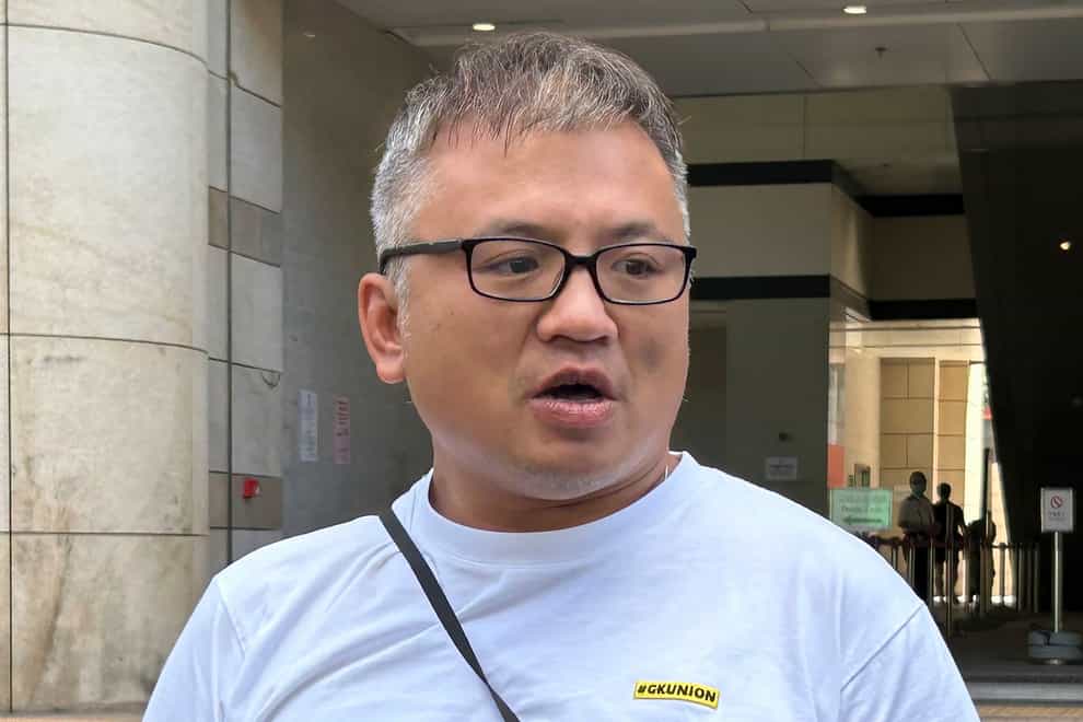The Hong Kong Journalists Association’s chairman Ronson Chan speaks to reporters outside court in Hong Kong on Monday (Kanis Leung/AP)