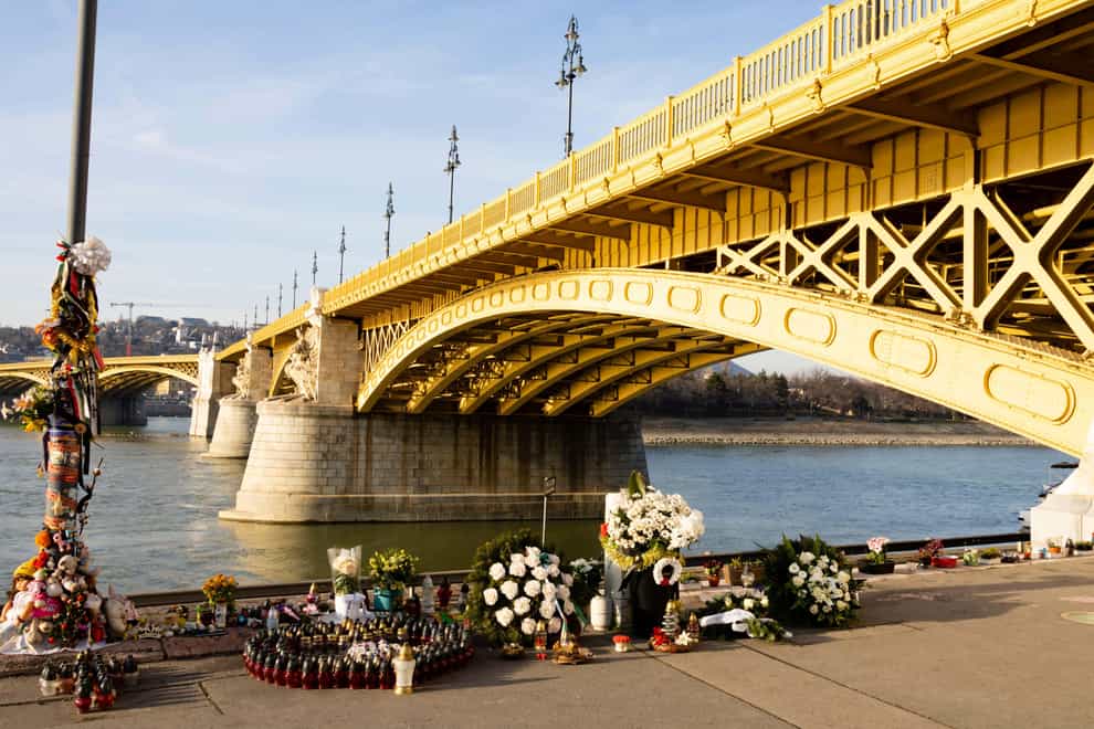 A shrine to 27 South Korean tourists who died when their cruise ship collided and sank under the Margaret Bridge, Budapest, in 2019 (Alamy/PA)