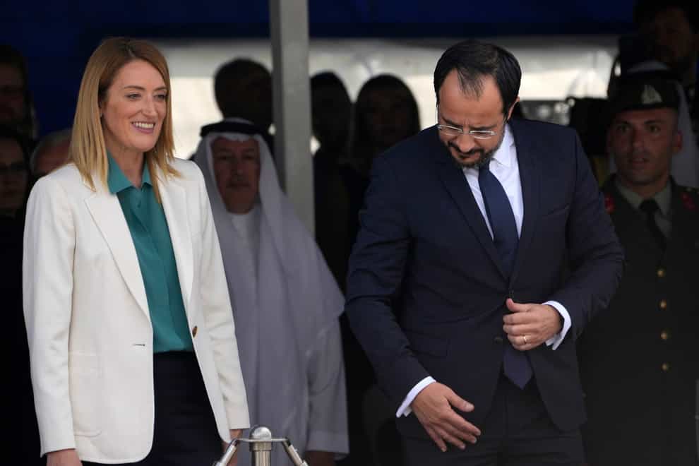 The parliament’s president Roberta Metsola, left, attended a military parade with Cyprus president Nikos Christodoulides on Sunday (Petros Karadjias/AP)