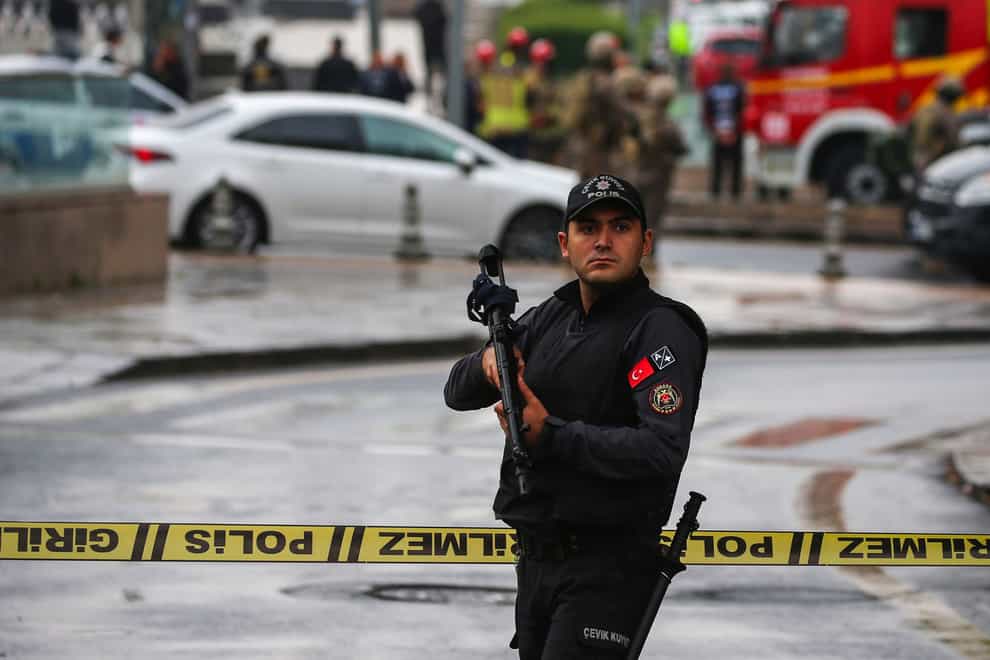 A member of Turkish security forces stands guard near a cordoned off area after an explosion in Ankara (AP Photo/Ali Unal)