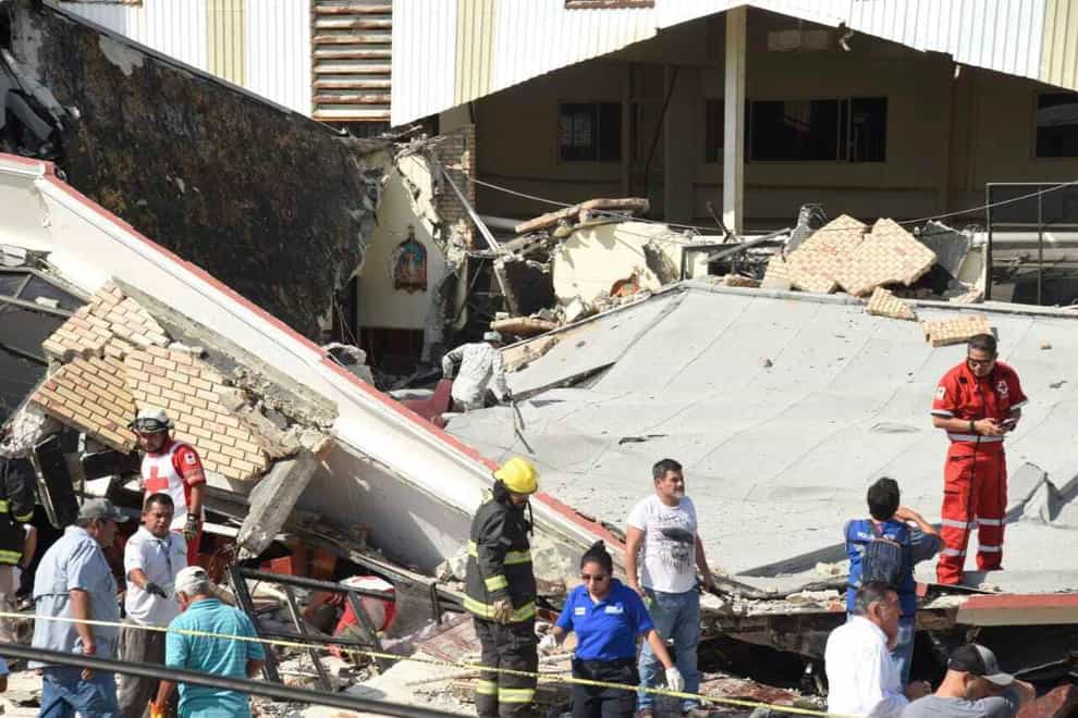 Rescue workers search for survivors amid debris after the roof of a church collapsed (Jose Luis Tapia/El Sol de Tampico/AP)