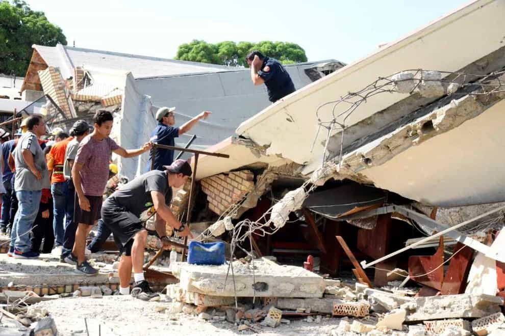 Rescue workers search for survivors amid debris after the roof of a church collapsed (Jose Luis Tapia/El Sol de Tampico/AP)