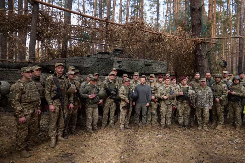 Ukrainian leader Volodymyr Zelensky with frontline troops (Ukrainian Presidential Press Office via AP)