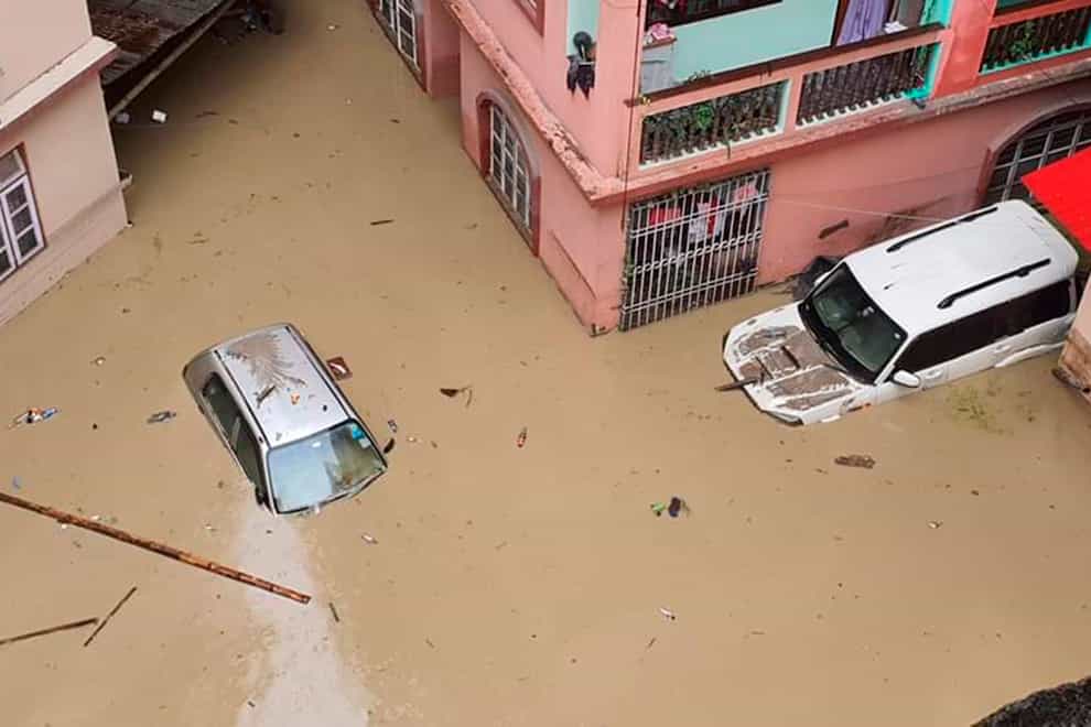 Cars lie submerged in water after flash floods triggered by a sudden heavy rainfall swamped the Rangpo town in Sikkim, India (Prakash Adhikari/ AP)